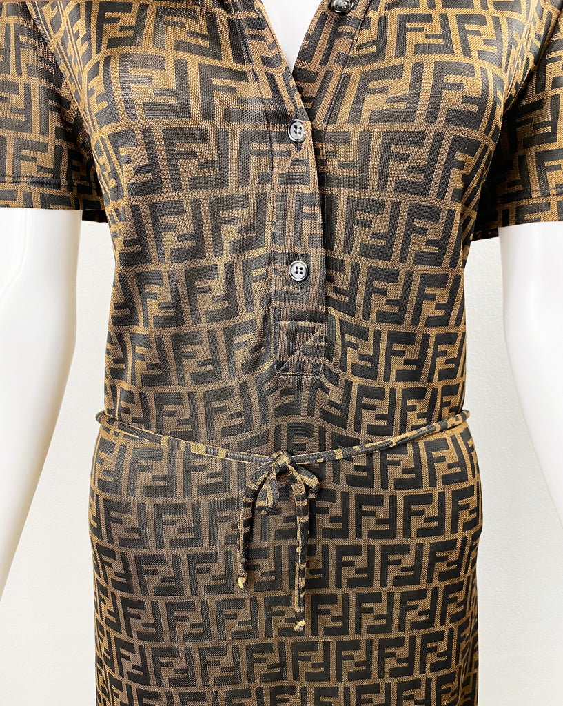 Fruit Vintage Fendi Zucca dress dating to the 90s it features a polo shirt dress cut, waist tie belt and a bold Fendi Zucca monogram logo print in black on brown.