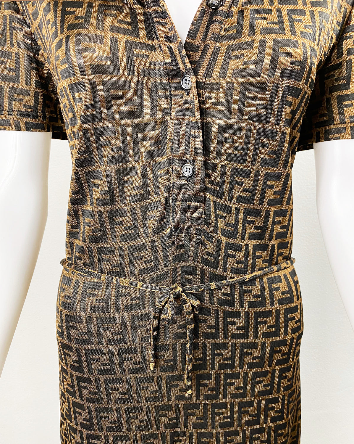 Fruit Vintage Fendi Zucca dress dating to the 90s it features a polo shirt dress cut, waist tie belt and a bold Fendi Zucca monogram logo print in black on brown.