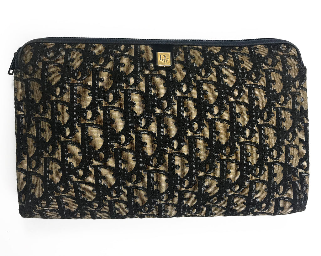 FRUIT Vintage Christian Dior 1980s navy trotter monogram clutch bag. Features a pochette style curved shape with top zipper and leather lining.