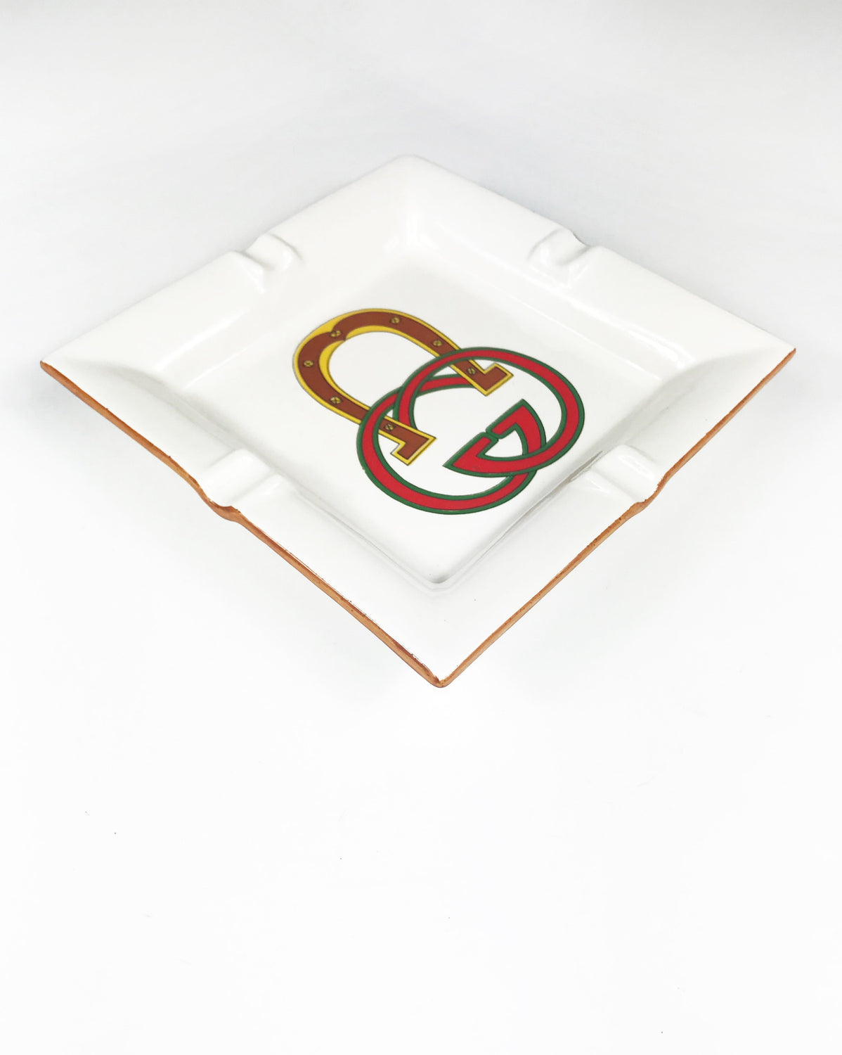 FRUIT Vintage Gucci hand painted 1980's porcelain logo ashtray or change tray. Features a classic ashtray shape, brown trim and Gucci suede logo fabric and mark at base. This is a very special piece!