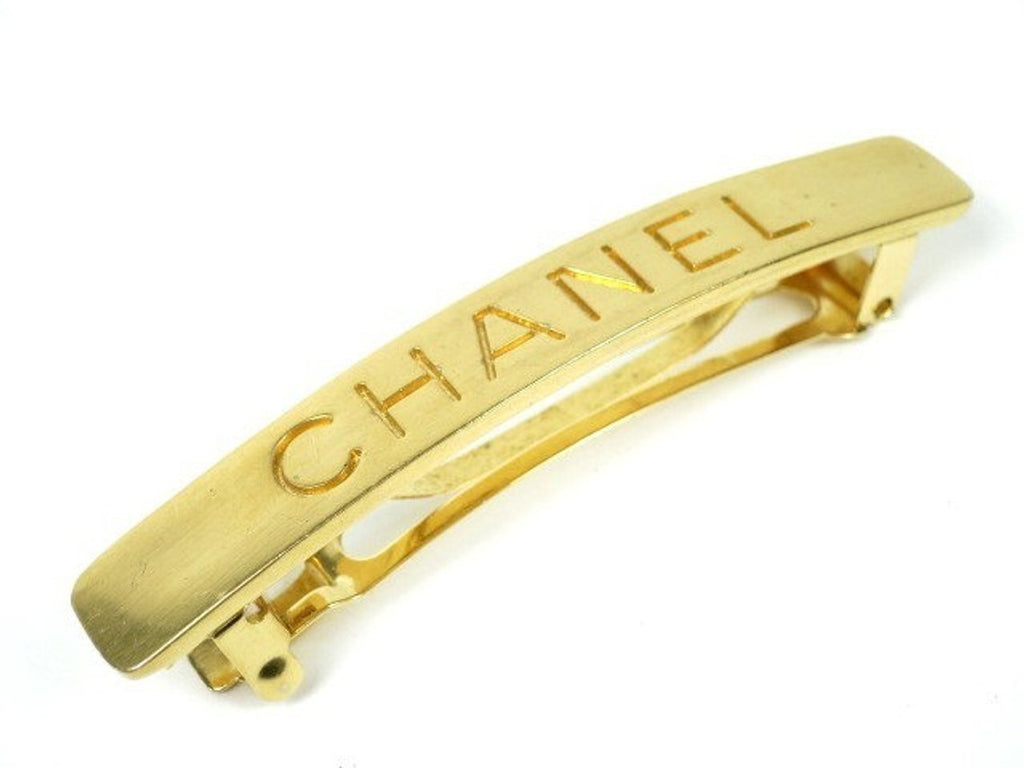 Fruit Vintage Chanel gold text logo barrette hair clip.