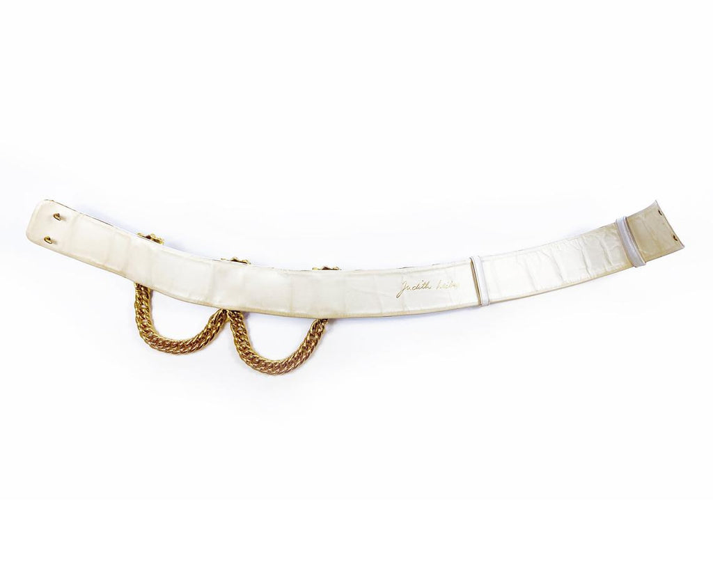 Fruit Vintage iconic Judith Leiber lion head belt with drop chains. This piece is amazing! It features 3 very large gold tone metal lions heads with drop chains on a white leather belt.