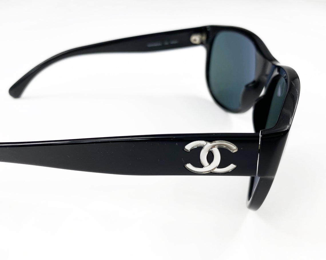 Fruit Vintage classic Chanel black logo sunglasses. They feature Chanel CC logo monograms to each side made from silver mirror.