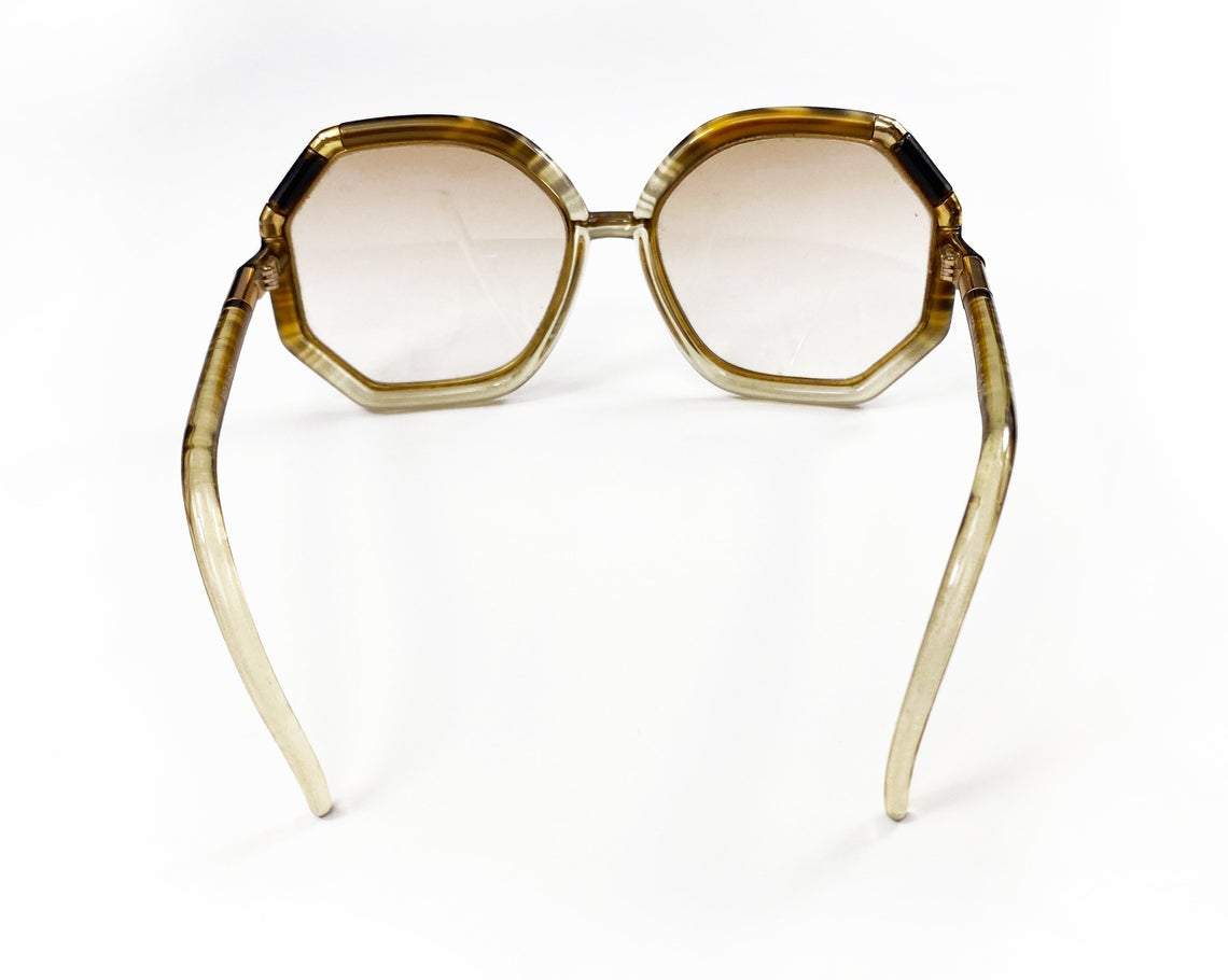 FRUIT Vintage iconic 1970s Ted Lapidus octagon oversized sunglasses in a brown and gold colour way. Made in France, they feature brown smokey lenses and a gold metal trim.