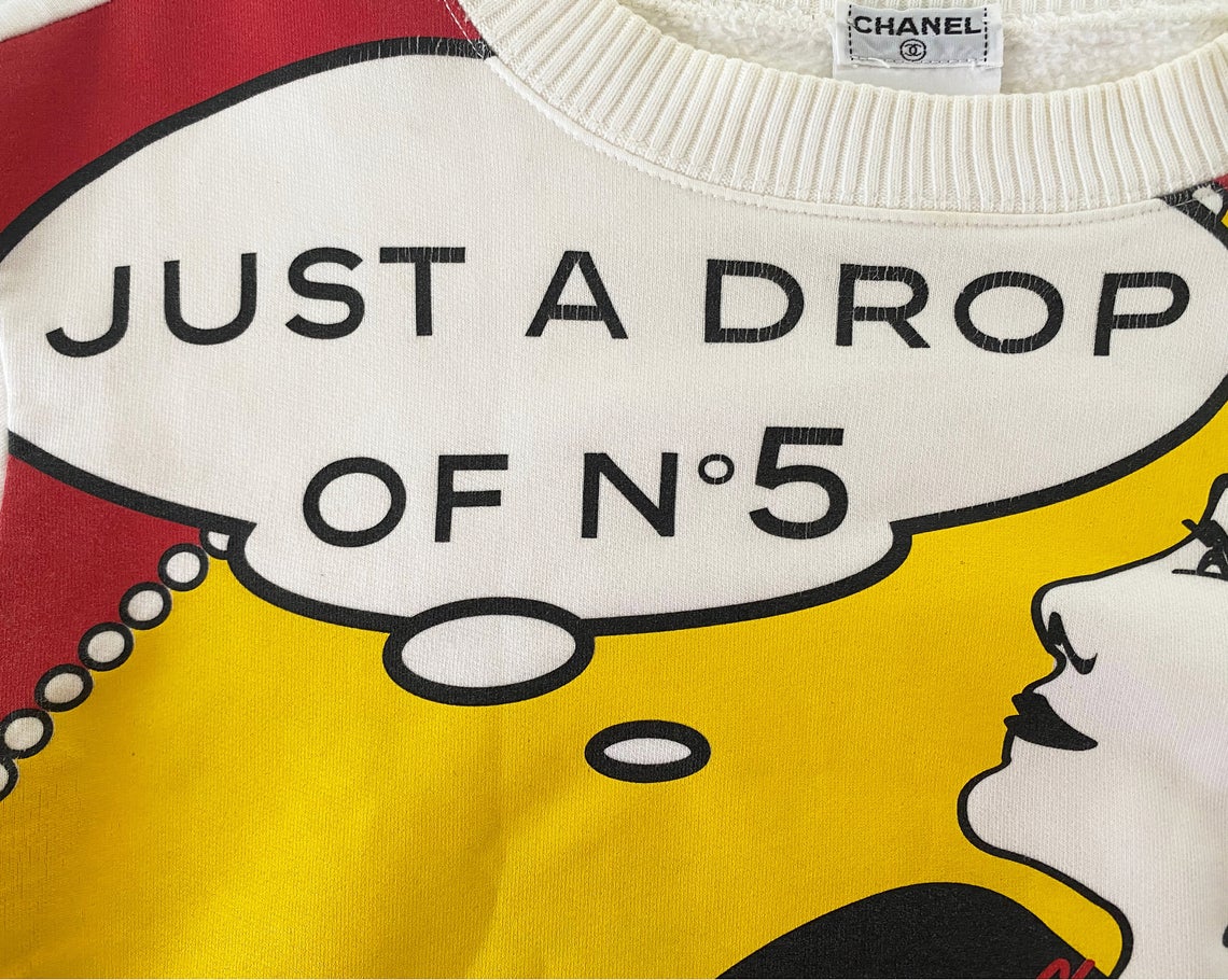FRUIT Vintage rare and important Chanel "Just a Drop of No. 5" sweatshirt from the Fall 2001 collection. It features a pop art Roy Lichtenstein inspired graphic art print of Coco Chanel and a cropped design and sleeves.