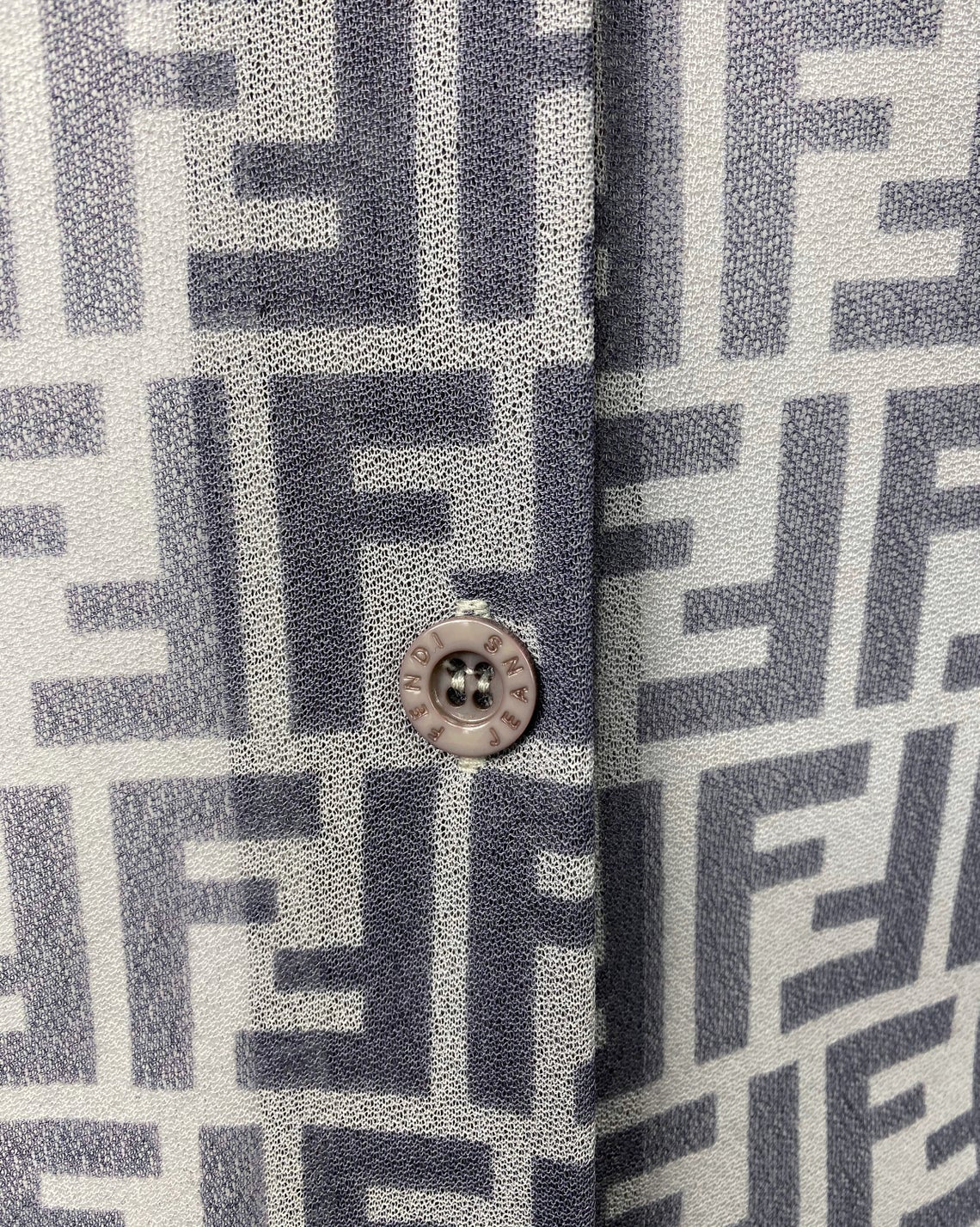 FRUIT Vintage Fendi Zucca print button up shirt dating to the early 90s. This amazing piece is made from a sheer mesh and features a bold Fendi Zucca print in two tone grey.