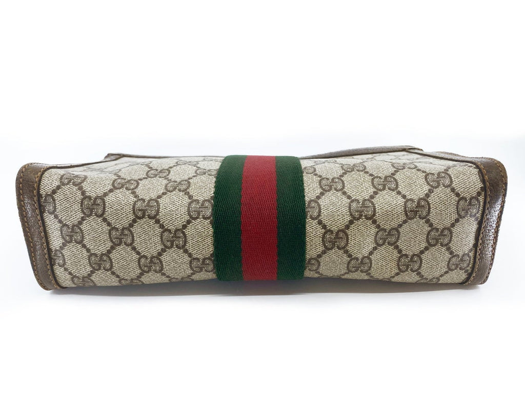 FRUIT Vintage Gucci 1980s Logo monogram canvas clutch bag. It features the iconic Gucci logo coated canvas, green and red fabric stripe, and velcro top closure.