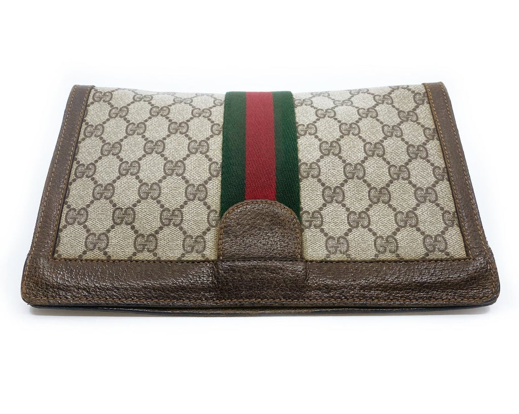 FRUIT Vintage Gucci 1980s Logo monogram canvas clutch bag. It features the iconic Gucci logo coated canvas, green and red fabric stripe, and velcro top closure.