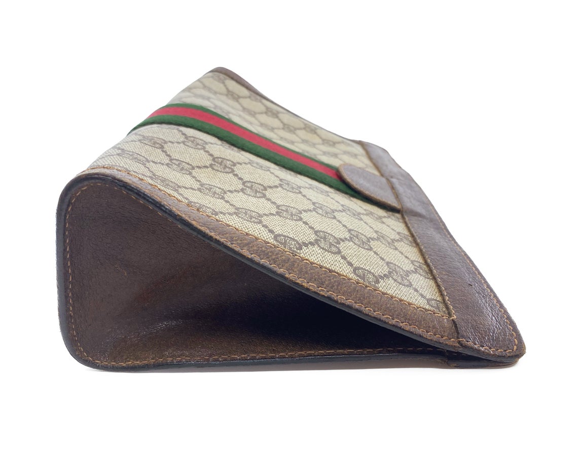 Beige GG-Supreme canvas wristlet pouch | Gucci | MATCHES UK
