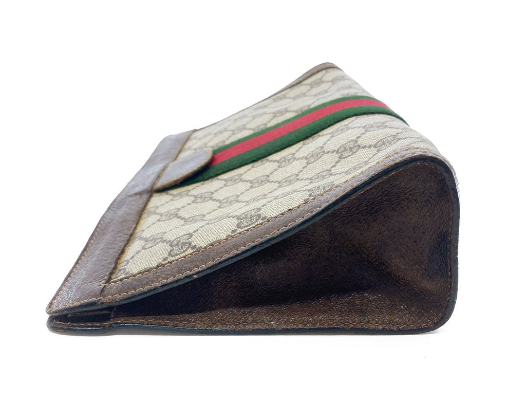 FRUIT Vintage Gucci 1980s Logo monogram canvas clutch bag. It features the iconic Gucci logo coated canvas, green and red fabric stripe, and velcro top closure.