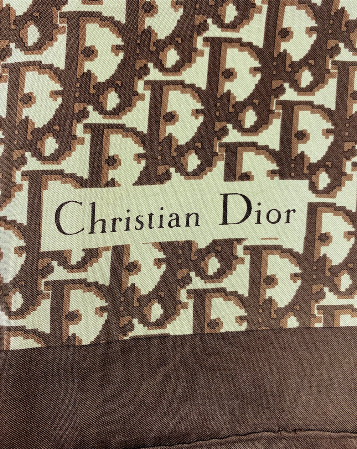 Fruit Vintage Christian Dior oblique print silk scarf in brown. Features a bold graphic Dior logo print and hand finished rolled hem edging.