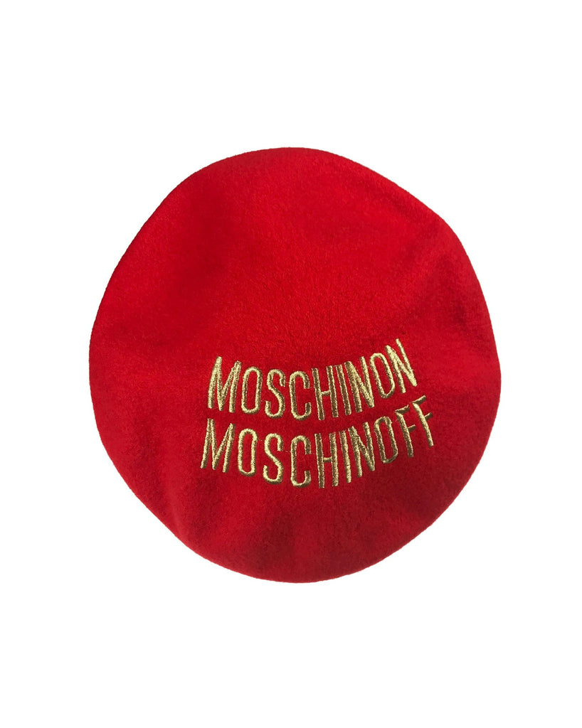 FRUIT Vintage Moschino logo beret hat. It features large embroidered gold text with the slogal "Moschinon Moschinoff" and a classic beret hat shape.