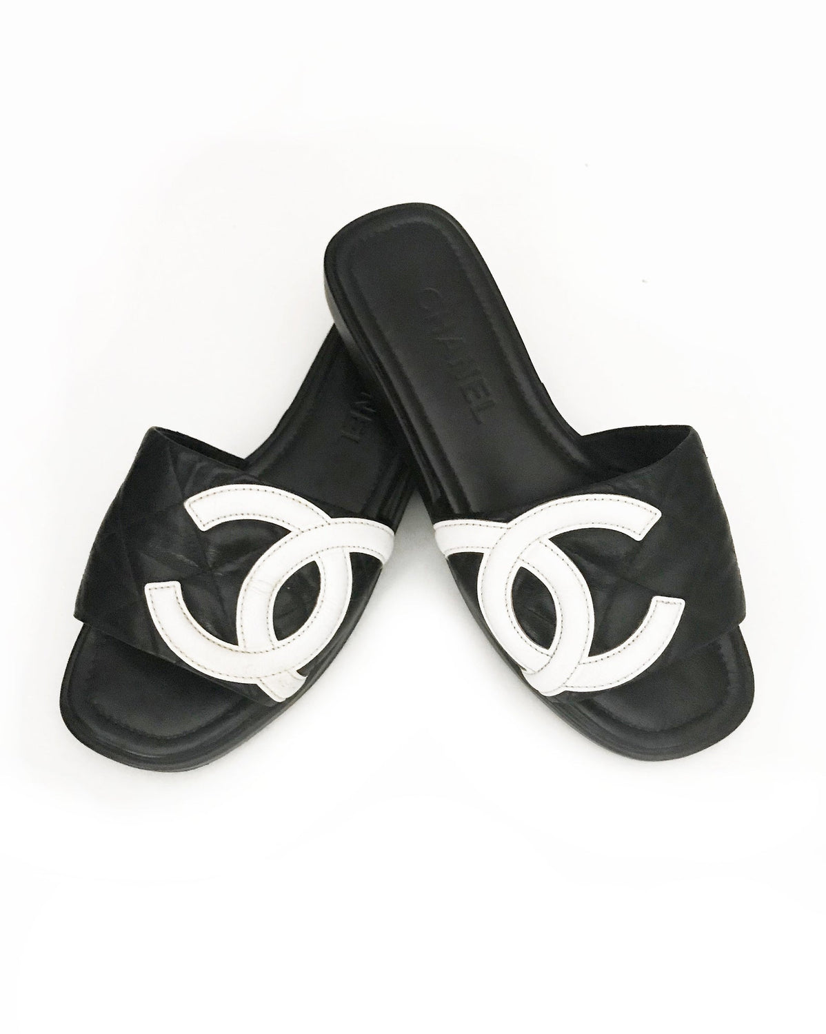 Fruit Vintage black Chanel logo slides with classic Chanel quilted leather with large CC monogram logos to the outer sides of each shoe.