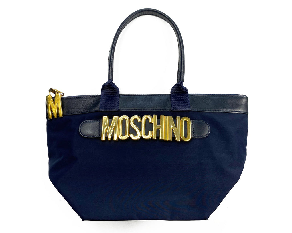 FRUIT Vintage Moschino mini tote bag with the iconic Moschino gold lettering at front. Features a top zipper closure with M logo zipper pull, Moschino logo lining, Moschino Redwall authenticity stamp and logo plaque at side.