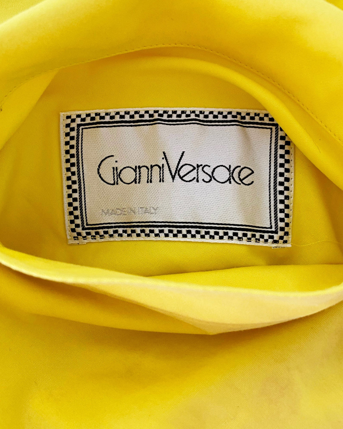 FRUIT Vintage Gianni Versace Vogue print coat from the iconic Spring 1991 runway collection. It features the iconic Vogue print in large scale all over and is fully reversible with a yellow cotton lining. This coat is a true piece of fashion history!