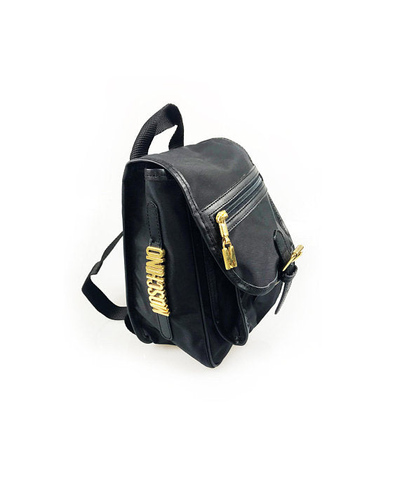 FRUIT Vintage Moschino mini backpack bag with the iconic Moschino gold lettering logo to one side, classic Moschino M logo zipper pull, and Redwall logo lining.