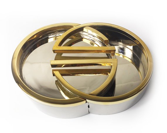 Fruit Vintage rare 1980's Gucci Logo double G ashtray set comprised of two interlocking gold and silver metal G-Shaped trays. This is the most amazing vintage designer home piece!