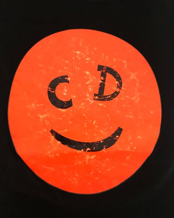Fruit Vintage Christian Dior Smiley face logo tee printed with a neon orange smiley face with CD logo eyes.