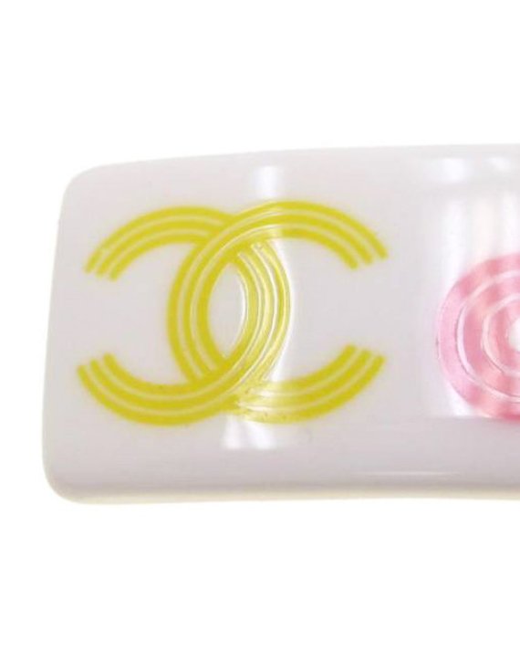 Fruit Vintage Chanel text logo barrette in white with bright logos. Features large Chanel text logos and two CC monograms either side.