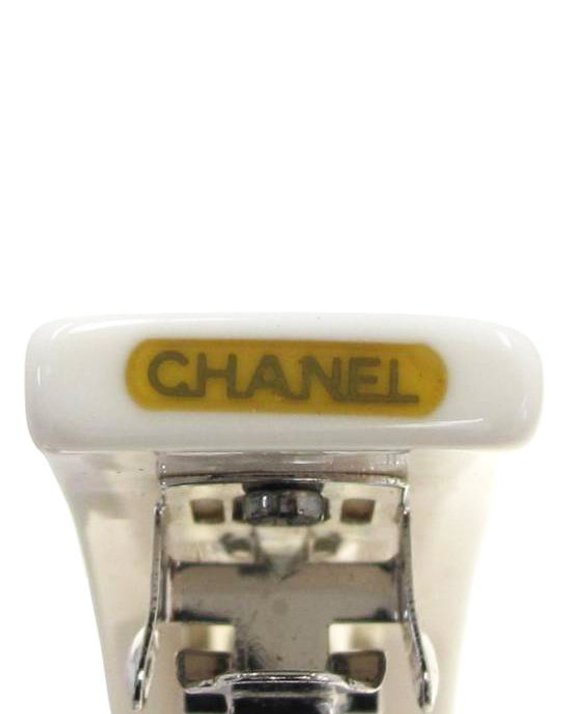 Fruit Vintage Chanel text logo barrette in white with bright logos. Features large Chanel text logos and two CC monograms either side.