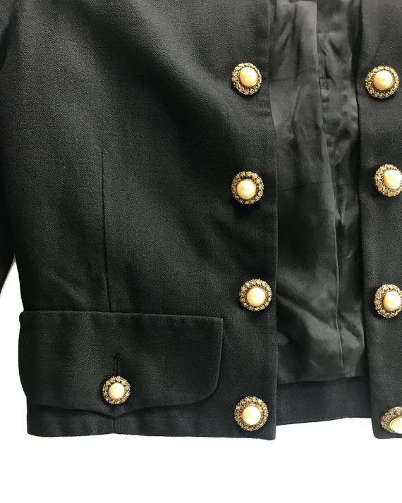 FRUIT Vintage rare Moschino Black Peace and Pearls jacket dating to 1989 in Mint condition. Hand sewn with a large pearl peace sign and the iconic Moschino monogram slogan text embroidered in gold.