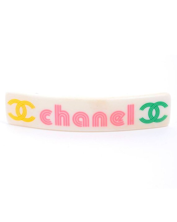 Fruit Vintage Chanel text logo barrette in white with bright logos. Features large Chanel text logos and two CC monograms either side.