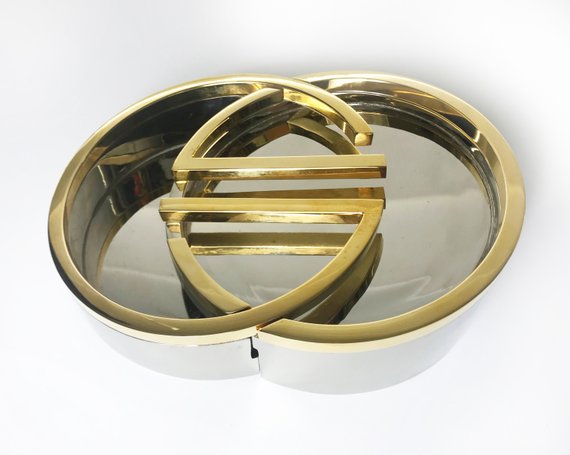 Fruit Vintage rare 1980's Gucci Logo double G ashtray set comprised of two interlocking gold and silver metal G-Shaped trays. This is the most amazing vintage designer home piece!