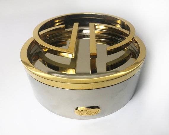 Fruit Vintage rare 1980's Gucci Logo double G ashtray set comprised of two interlocking gold and silver metal G-Shaped trays. This is the most amazing vintage designer home piece!