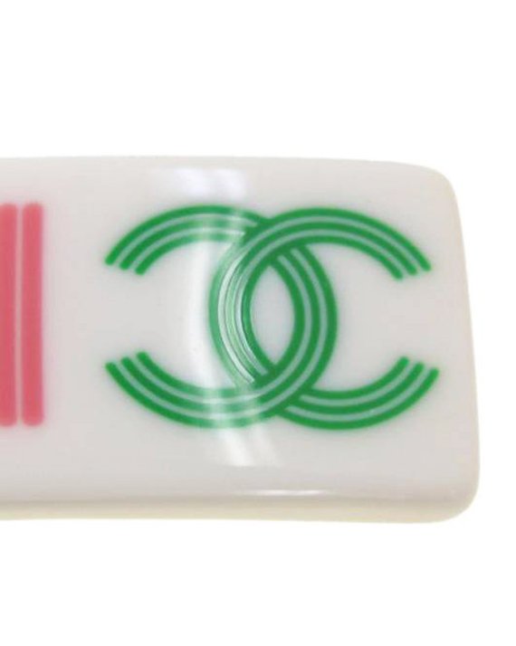 Fruit Vintage Chanel text logo barrette in white with bright logos. Features large Chanel text logos and two CC monograms either side.