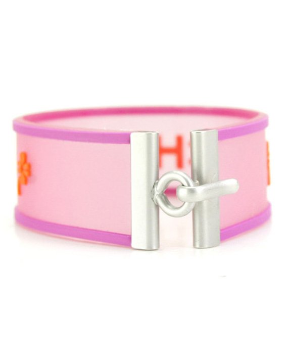 Fruit Vintage Chanel pink and orange rubber logo cuff bracelet with large CHANEL text logo to the centre and two clover symbols either side.