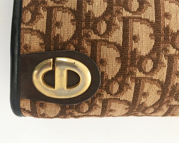 FRUIT vintage 1970s Christian Dior clutch bag is made of Brown oblique monogram logo trotter print canvas and features a gold hardware clip top closure. 