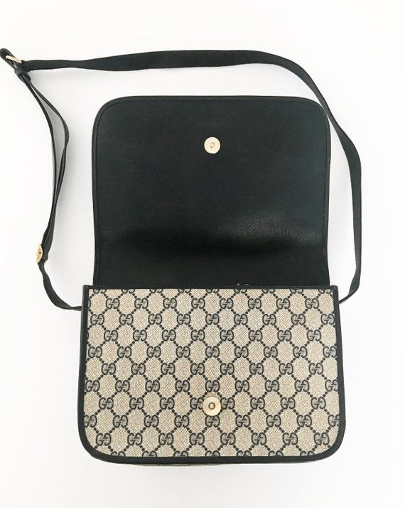  Fruit Vintage Gucci 1980s Logo embellished cross body satchel bag in a navy coated version of the classic Gucci monogram canvas. 