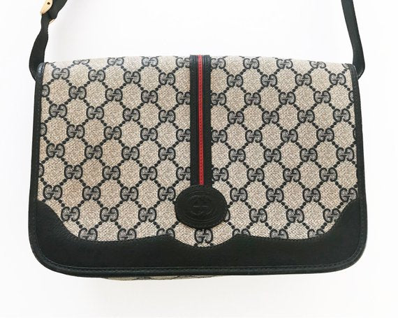  Fruit Vintage Gucci 1980s Logo embellished cross body satchel bag in a navy coated version of the classic Gucci monogram canvas. 
