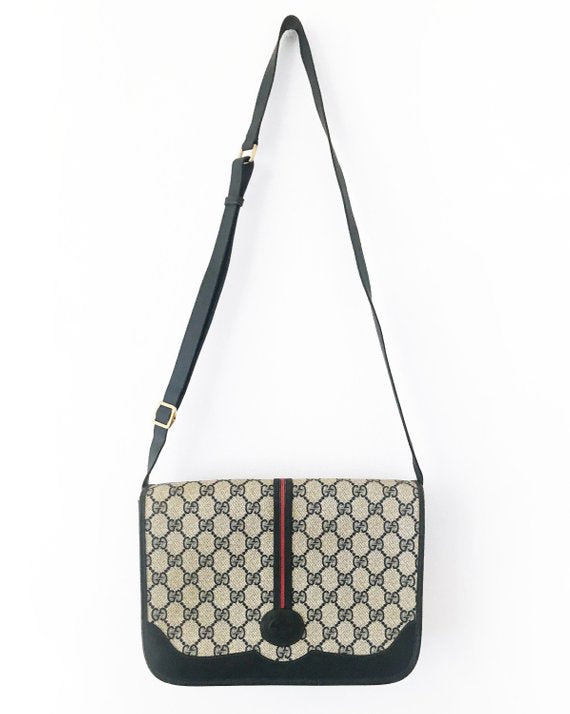  Fruit Vintage Gucci 1980s Logo embellished cross body satchel bag in a navy coated version of the classic Gucci monogram canvas. 