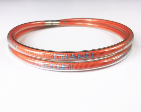Fruit Vintage Chanel orange wrap around rubber tubing choker with CHANEL text logo all around.
