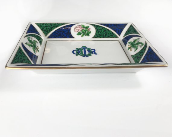 FRUIT Vintage Christian Dior very rare porcelain change tray featuring the 1980s logo in the center surrounded by vibrant green and blue tones and floral motifs.