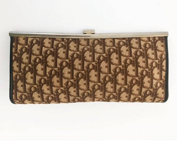 FRUIT vintage 1970s Christian Dior clutch bag is made of Brown oblique monogram logo trotter print canvas and features a gold hardware clip top closure. 