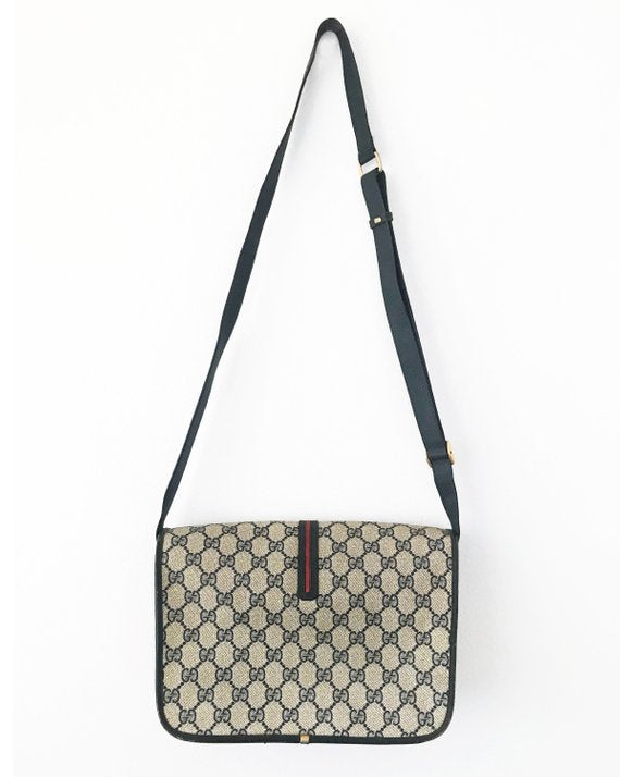  Fruit Vintage Gucci 1980s Logo embellished cross body satchel bag in a navy coated version of the classic Gucci monogram canvas. 