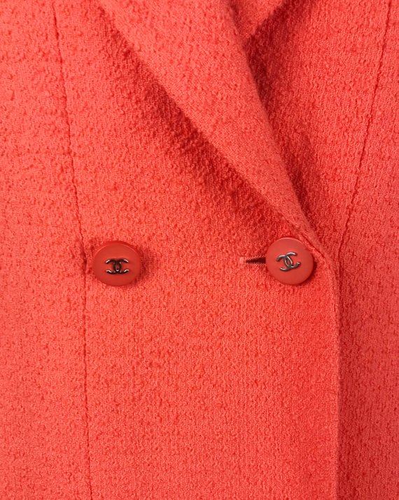 Fruit Vintage Chanel boucle jacket in pale neon peach tone. This jacket is from the famous Spring/Summer 1996 RTW collection by Karl Lagerfeld. It features a longer-line length, classic Chanel logo buttons, internal chain hem and two front pockets.