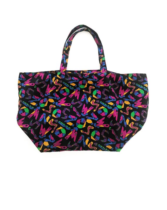Fruit Vintage 1980s Missoni beach bag in a psychedelic logo printed nylon fabric. Features a zipper closure at top and internal zipped pocket.