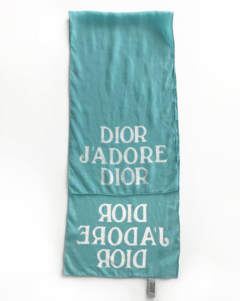 FRUIT vintage Christian Dior rare J'adore Dior logo monogram silk scarf perfect for use as a hair accessory, to tie around a hat or when worn around the neck. Features a bold graphic Dior logo print on both ends and hand finished rolled hem edging