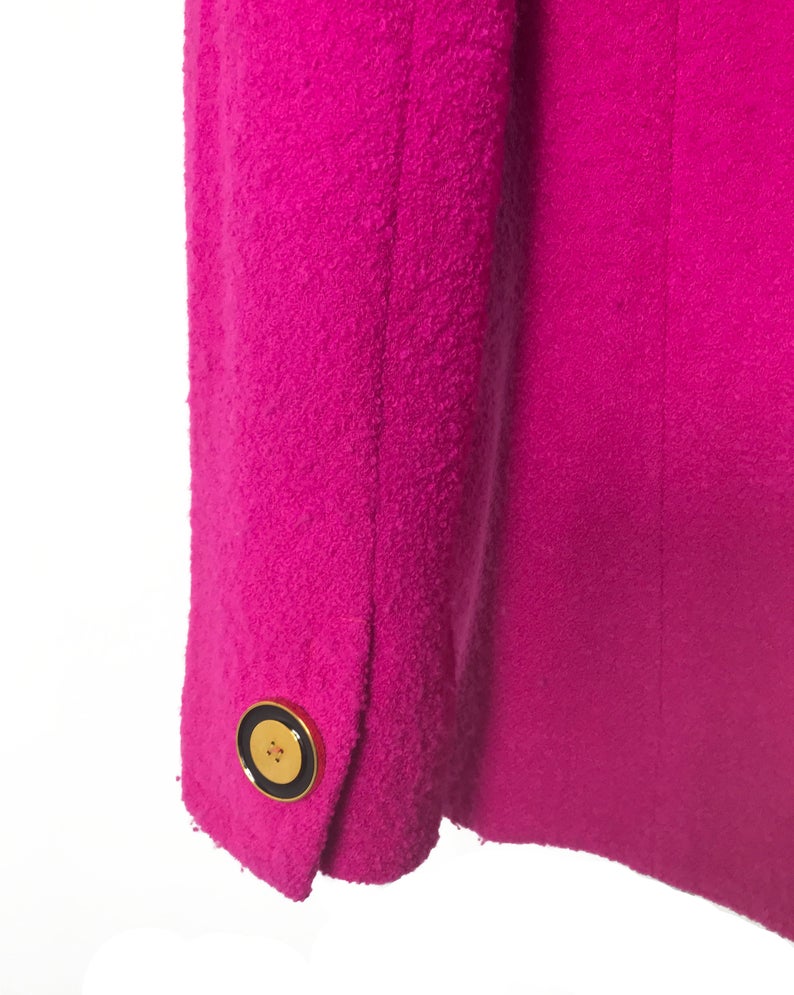 A fabulous bright pink Givenchy jacket dating to the 1980s. This bright piece features a contrast grey trim and large gold buttons.