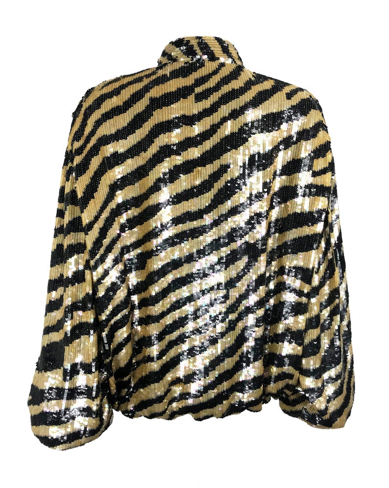 FRUIT Vintage sequinned zebra print bomber jacket by Jeanette Kastenberg for St Martin Sport. It features a bold full sequin 2 tone zebra print, push button closure and elasticated waist and sleeves
