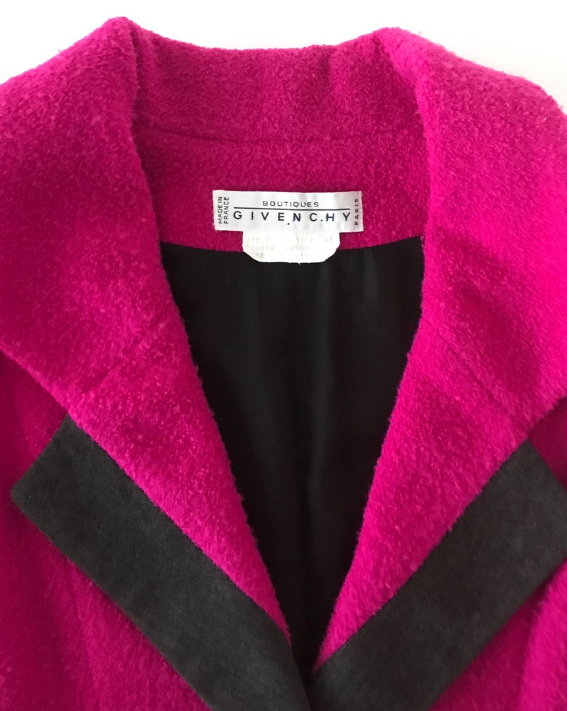 A fabulous bright pink Givenchy jacket dating to the 1980s. This bright piece features a contrast grey trim and large gold buttons.