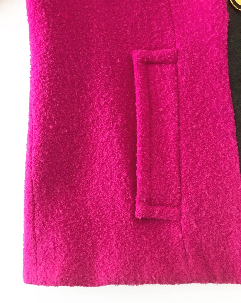 A fabulous bright pink Givenchy jacket dating to the 1980s. This bright piece features a contrast grey trim and large gold buttons.