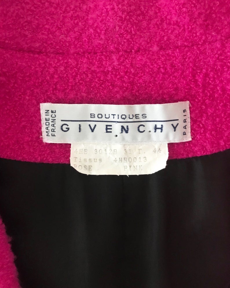 A fabulous bright pink Givenchy jacket dating to the 1980s. This bright piece features a contrast grey trim and large gold buttons.