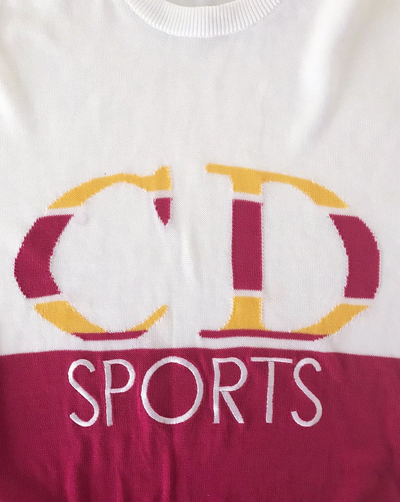 Fruit Vintage Christian Dior Sport CD sweat shirt from the 1980s. It features an large embroidered CD logo at front woven intarsia style into the knit fabric and a removable polo collar