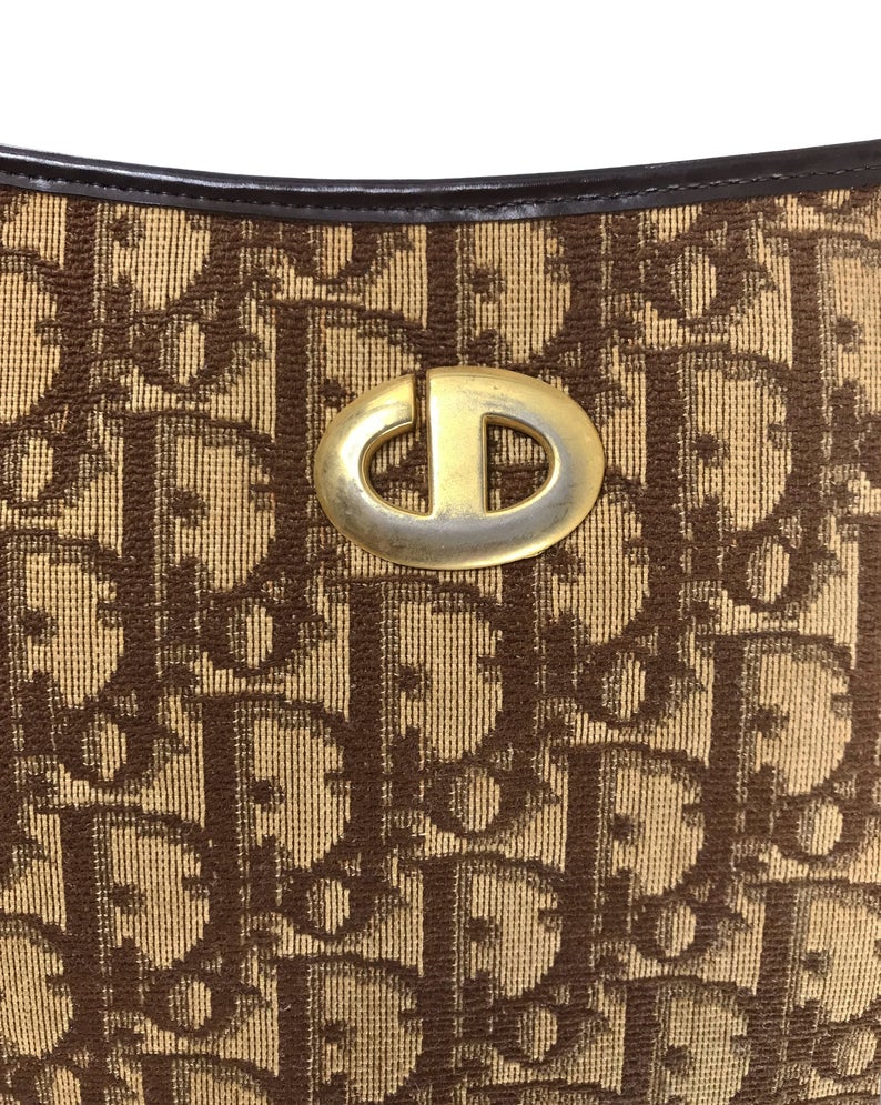 FRUIT vintage 1970s Christian Dior brown monogram canvas handbag. Features a simple 'hobo' style shape perfect for wear on the shoulder, gold CD logo at front, and simple zip top closure.