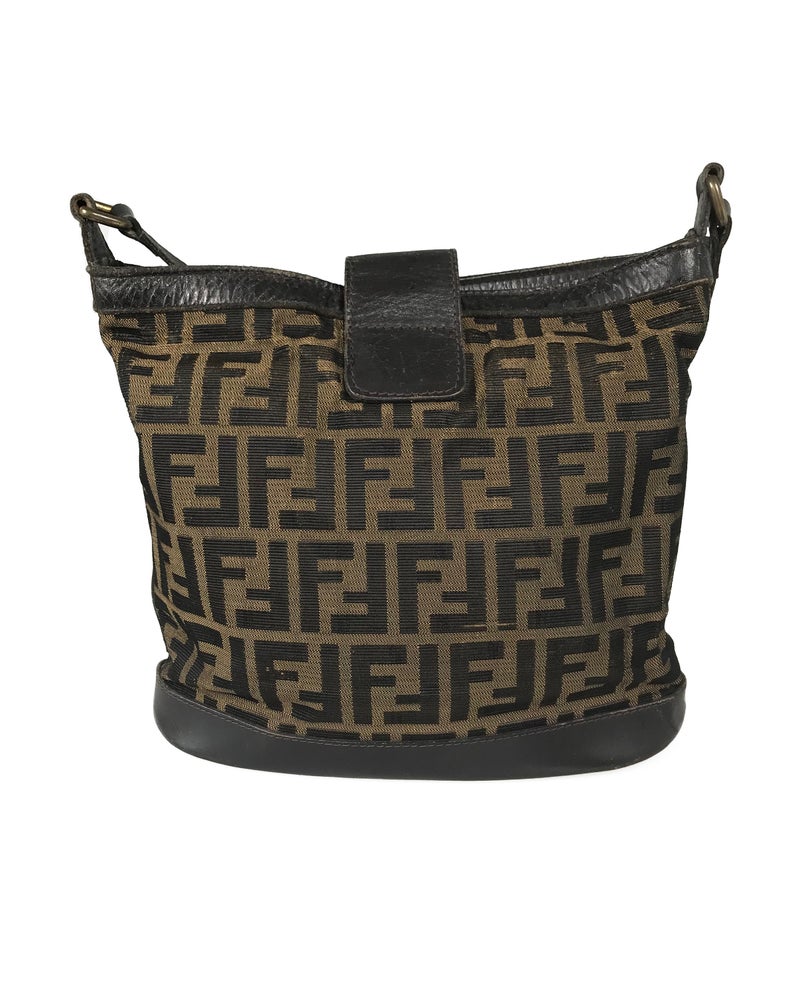 FRUIT Vintage Fendi Zucca cross body bucket bag dating to the 1980s. It features the classic Fendi Zucca monogram canvas, front embossed logo, top push button closure and long adjustable cross body strap..