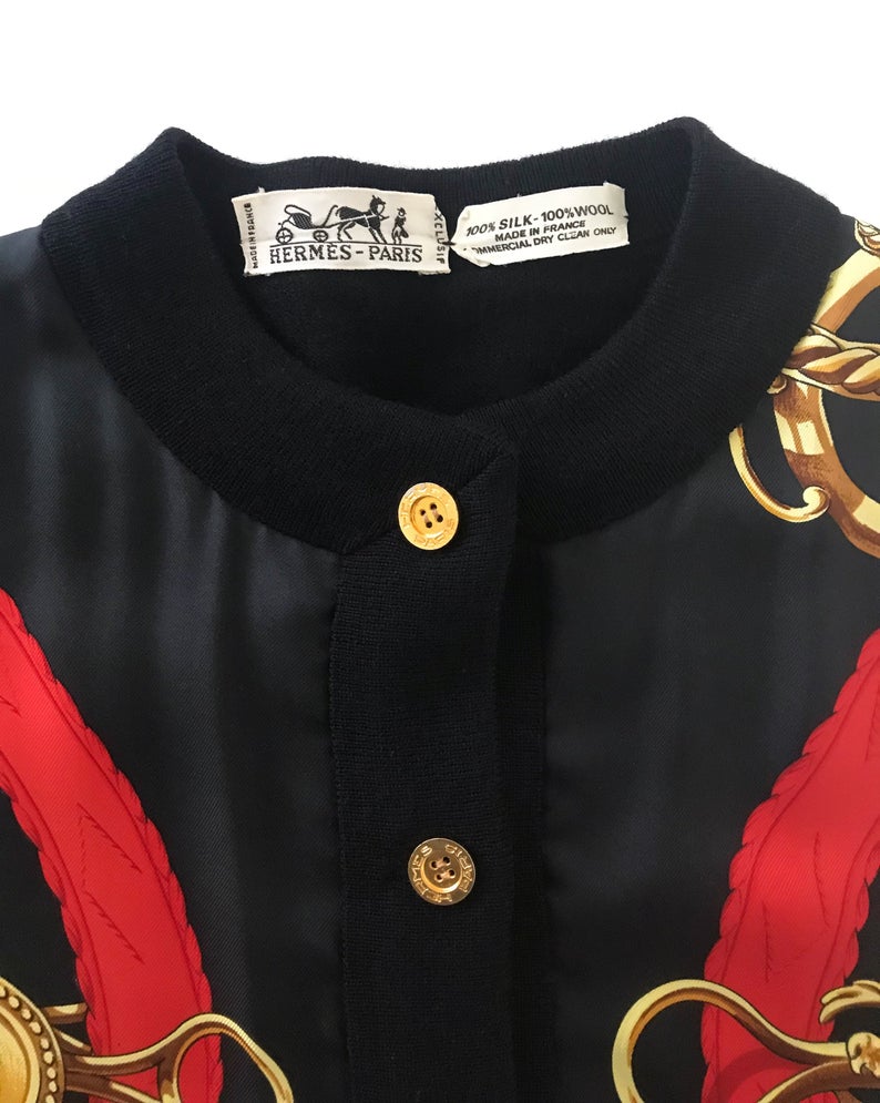 FRUIT Vintage Hermes classic in near mint condition, this cardigan is a beautiful piece of vintage Hermes history! It features an equestrian inspired silk scarf print at the front, full wool rear and gold logo buttons.